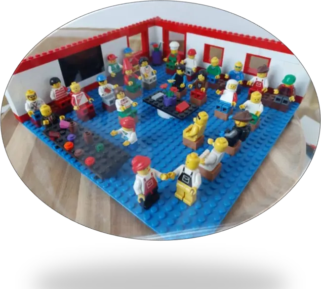 Lego minifigures sitting around a table with flowers on it